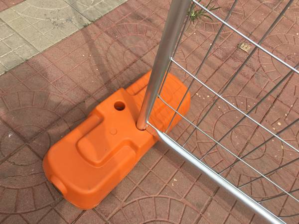An Australia temporary fence is inserted into one hole of the plastic feet.