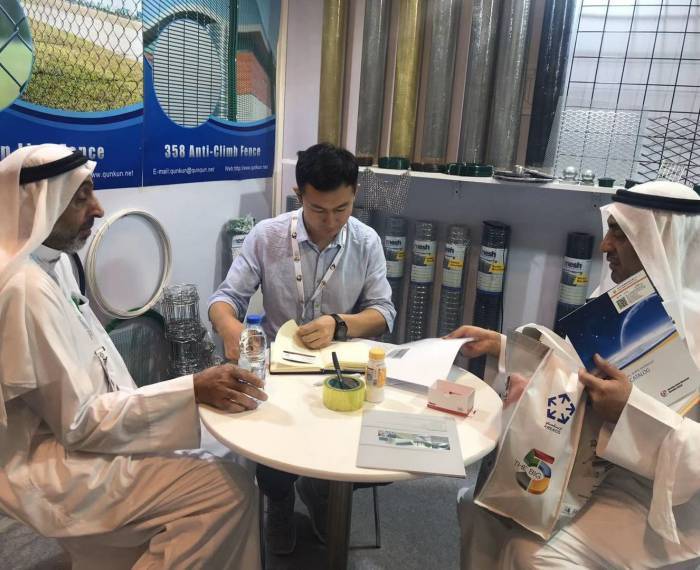 Our sales representative is calculating price for our customers in our exhibition booth.