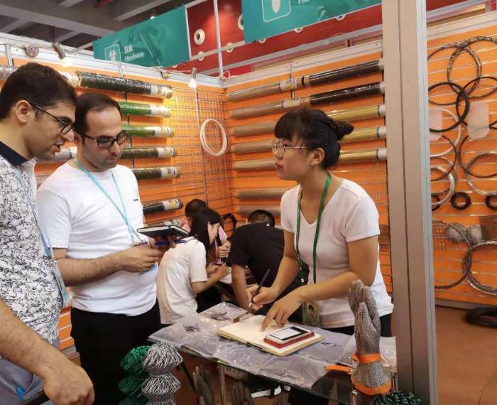 Our sales representative is introducing products for our customers in our exhibition booth.